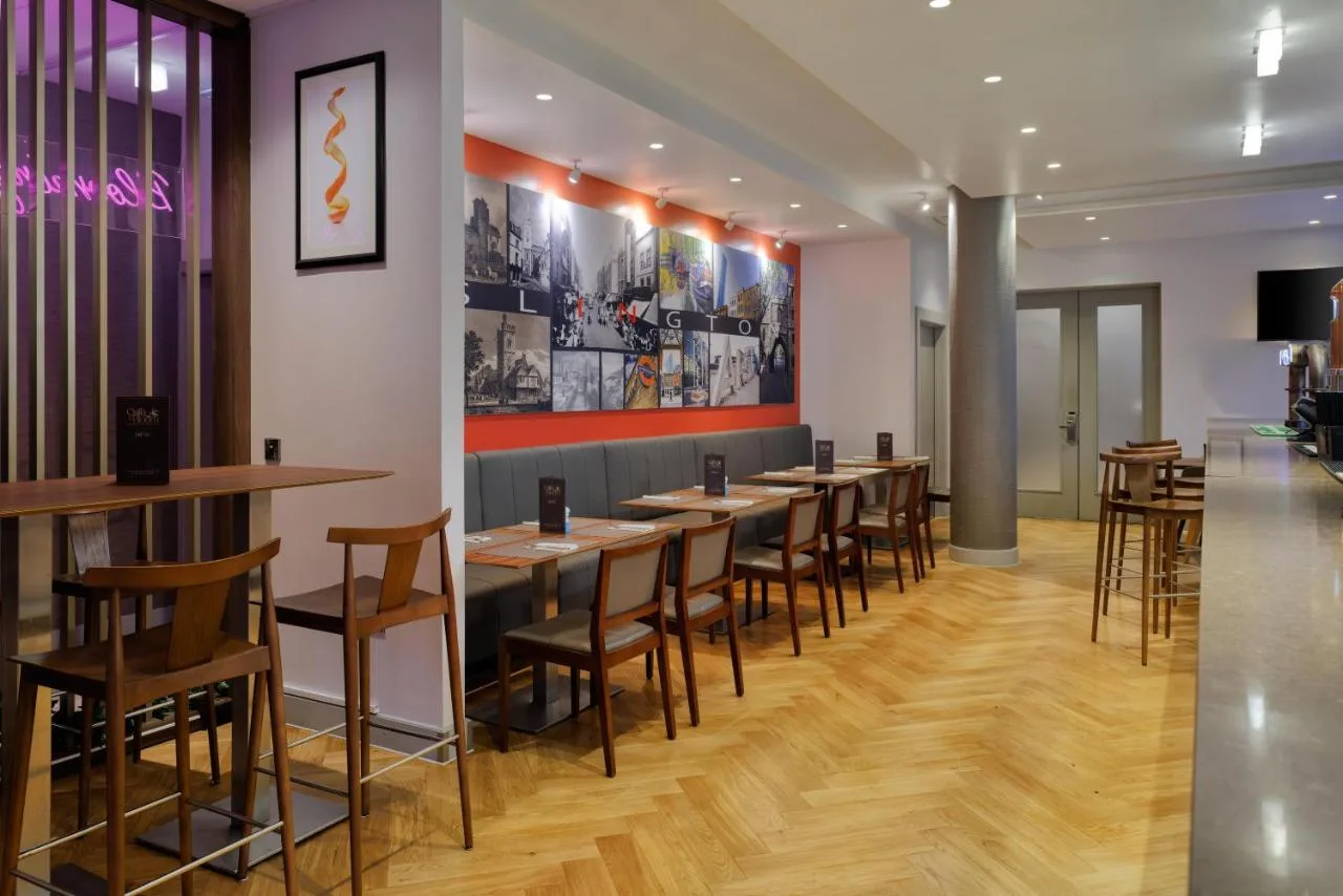 a row of tables and chairs in a restaurant at DoubleTree by Hilton London Angel Kings Cross in London
